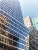 Wide angle upward view of Buildings and trees near Bryant Park in NYC