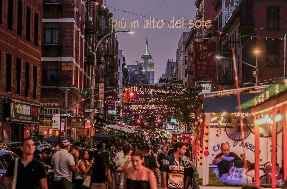A group of people walking down Little Italy in New York City