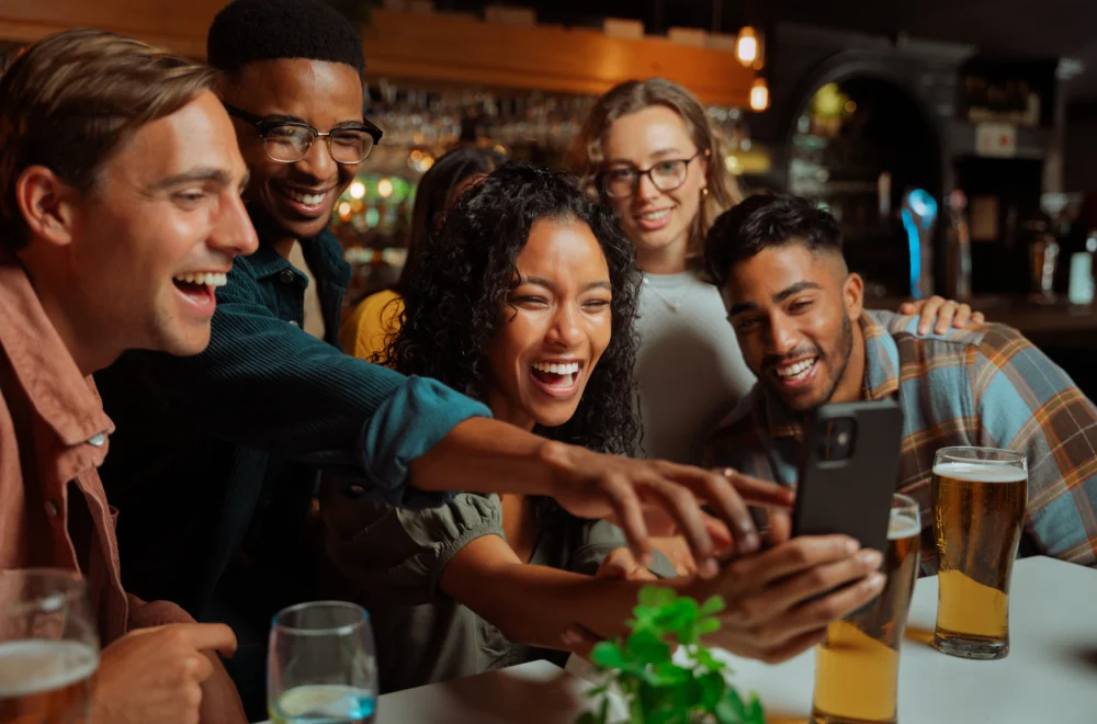 Dinner guests taking selfie at dinner table in NYC