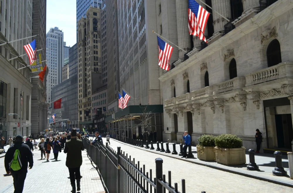People walking down Wall Street in New York City