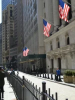 People walking down Wall Street in New York City