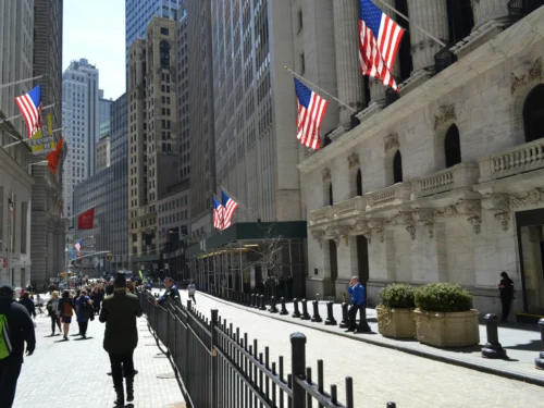 People walking down Wall Street in New York City