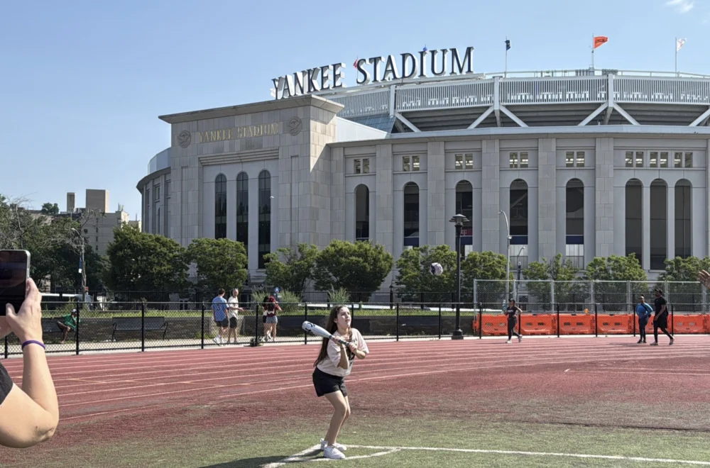 Tourists playing baseball outside of the Yankee Stadium during private guided tour in NYC