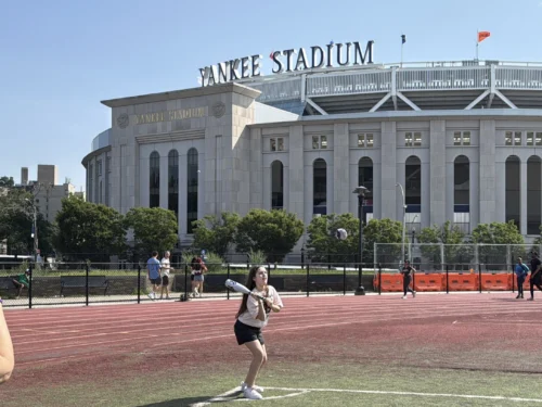 Tourists playing baseball outside of the Yankee Stadium during private guided tour in NYC