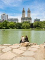 Two people sitting near the lake in Central Park during private NYC guided tour