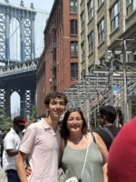 Two people taking a photo with Brooklyn Bridge during Beyond Manhattan private guided tour