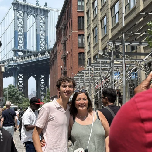Two people taking a photo with Brooklyn Bridge during Beyond Manhattan private guided tour