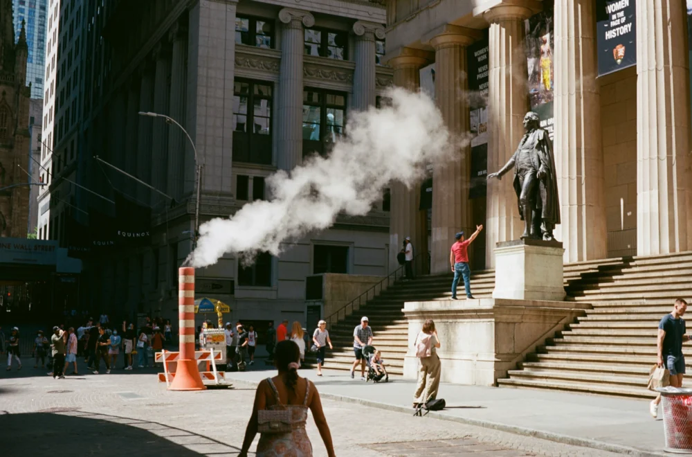 Woman walking past Federal Hall during Premium Financial Crisis tour