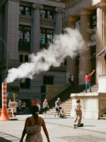 Woman walking past Federal Hall during Premium Financial Crisis tour