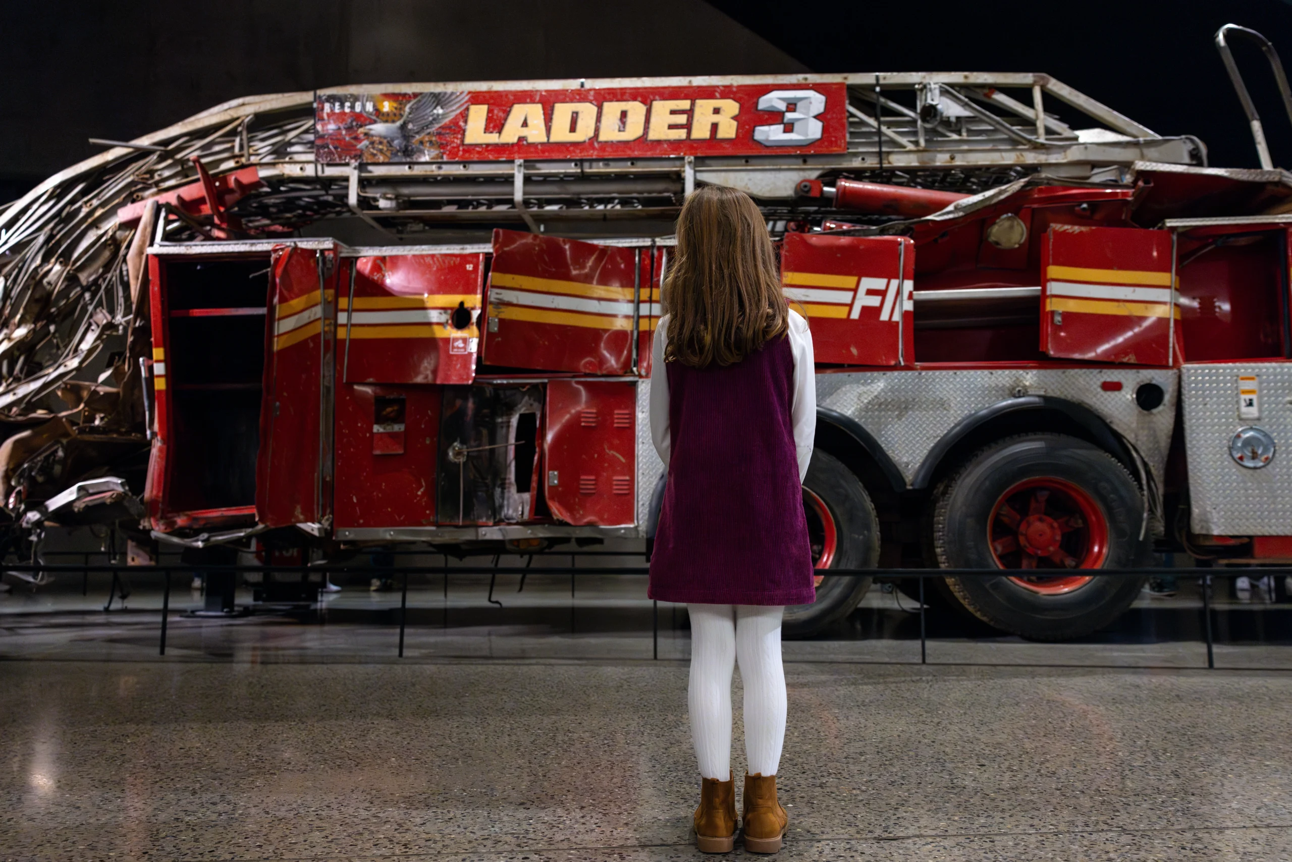 Girl looking at Ladder 3 exhibit in the 911 Museum