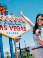 traveler pointing to the famous city sign