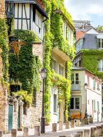 Cityscape view on the beautiful street with green buildings on Monmartre hill in Paris