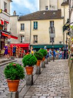 Cozy street with tables of cafe in quarter Montmartre in Paris, France
