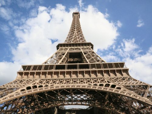 looking up at the summit of the Eiffel Tower