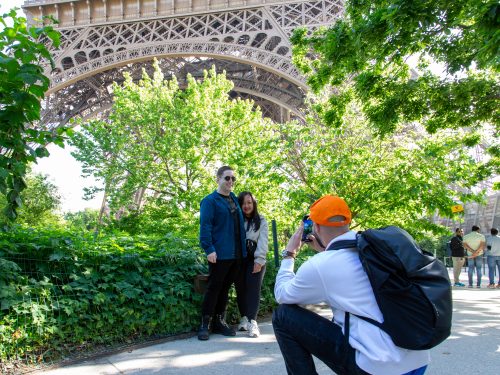 Eiffel Tower tour guide takes a photo of travelers