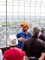 Guests on Eiffel Tower tour listen to tour guide