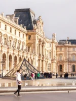 Tourists walking outside the Louvre in Paris
