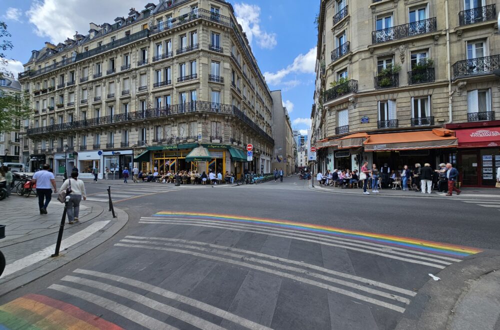 Pedestrian crosswalk with painted rainbow from both sides in Le Marais quarter in Paris