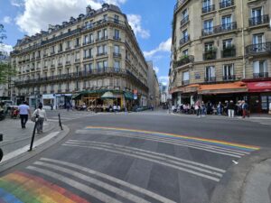 Pedestrian crosswalk with painted rainbow from both sides in Le Marais quarter in Paris