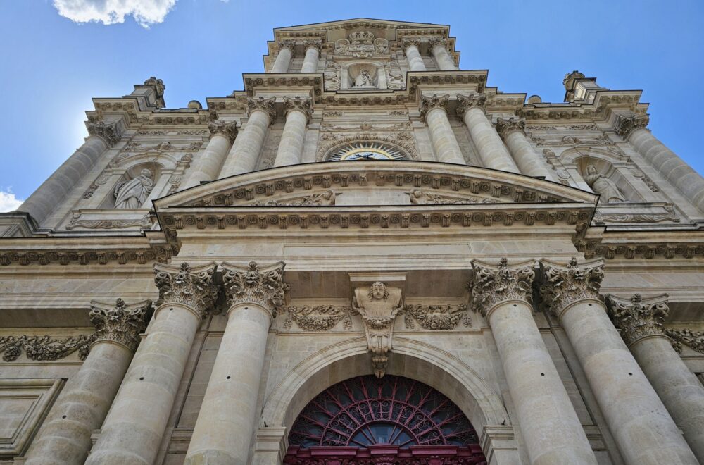 Ornate stone doorway of a historic Parisian church visited on the Le Marais tour.