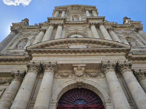 Ornate stone doorway of a historic Parisian church visited on the Le Marais tour.