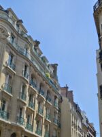 Elegant Haussmann-style architecture on a corner street in Le Marais, Paris.