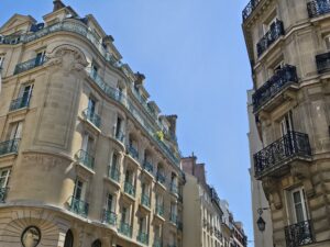 Elegant Haussmann-style architecture on a corner street in Le Marais, Paris.