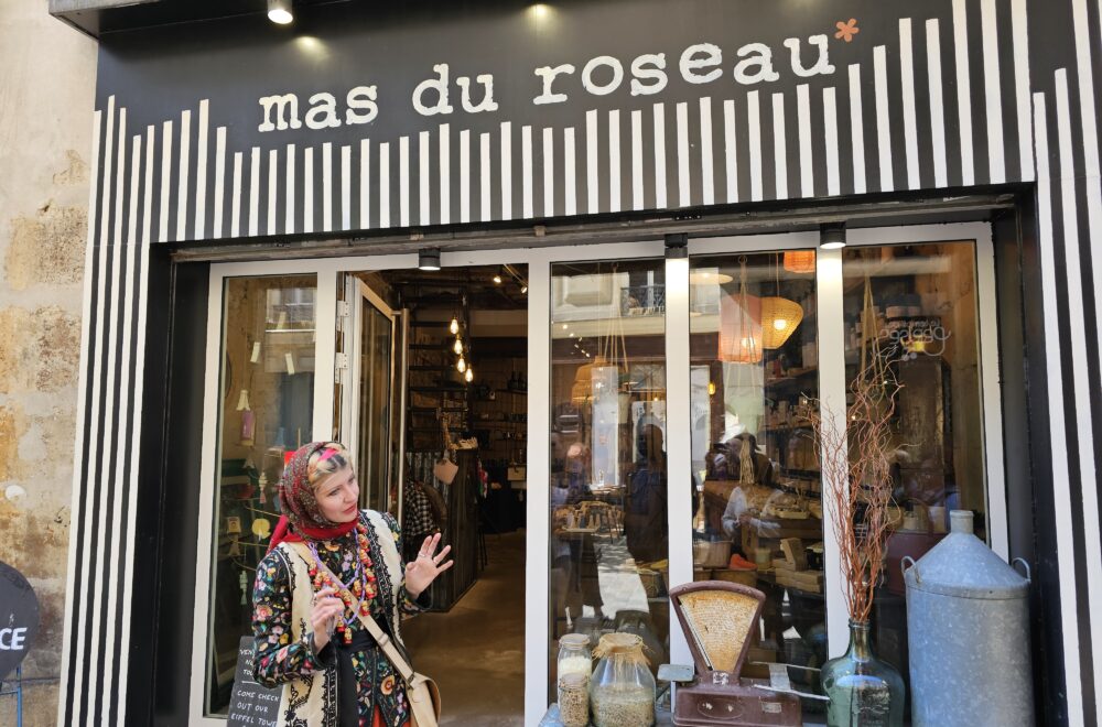 Tour guide introducing Mas du Roseau, a charming boutique in the heart of Le Marais.