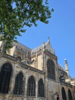 Contrasting view of Saint-Merri Church and colorful street art mural in Le Marais.