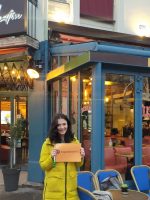 Pere Lachaise Walking Tour meeting point with tour guide holding sign