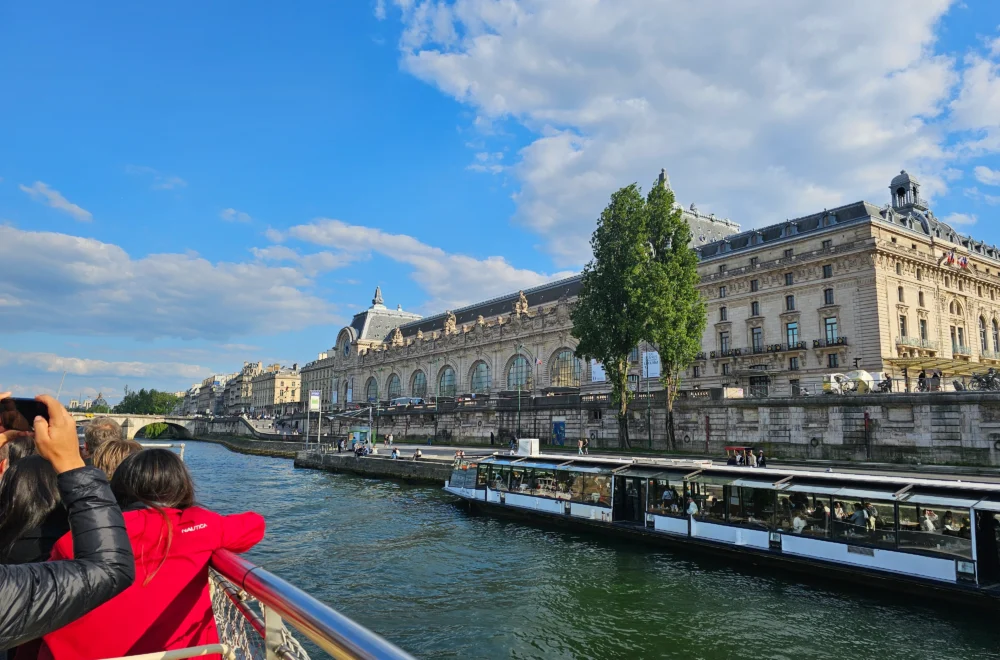 Travelers looking at the view during Seine River cruise