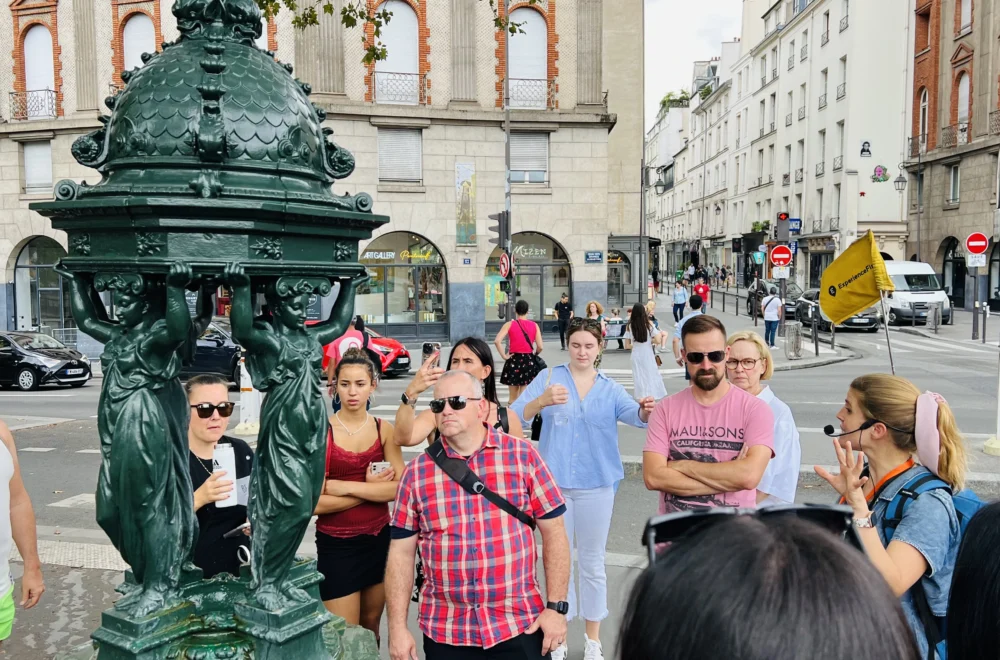 Guide and guests at Fontaine Wallace in Unofficial Emily in Paris tour