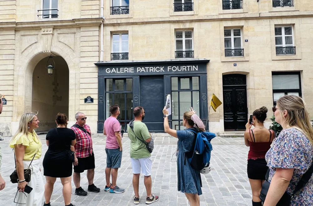 Guide explaining to the group during Unofficial Emily in Paris tour at Place de Valois