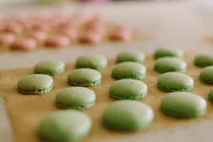 Green macarons on baking sheet during Macaron Baking Class in Paris