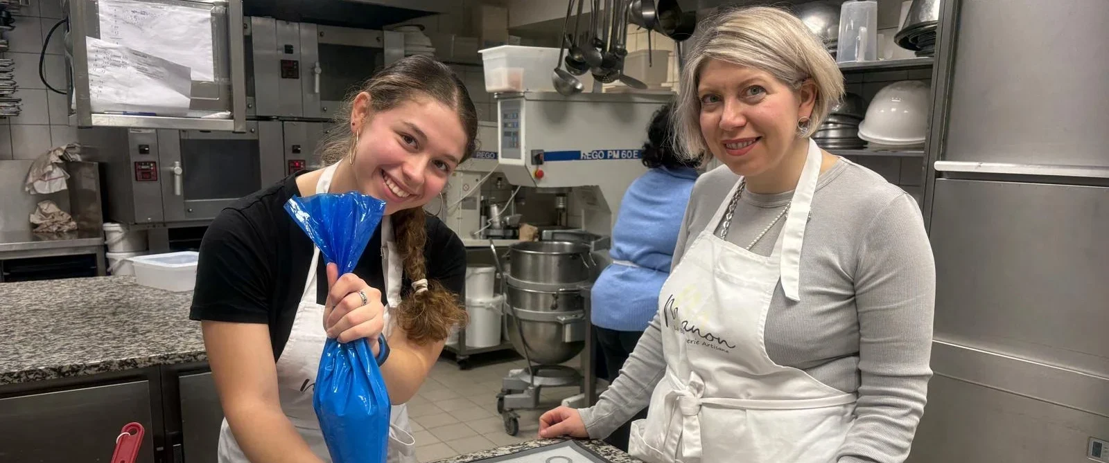 Guest piping macaron mixture during Macaron Baking Class