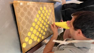 Piping yellow macaron mix