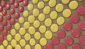 Tray of yellow and pink macarons