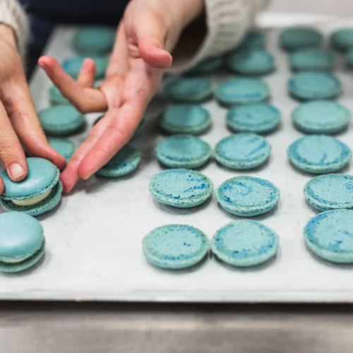 Woman assembling macarons during Macaron Baking Class in Paris