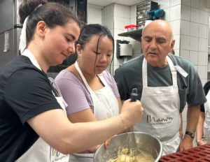 Baking class students mixing dough in Paris bread class