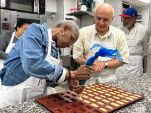 Guest making madeleines in French bread class