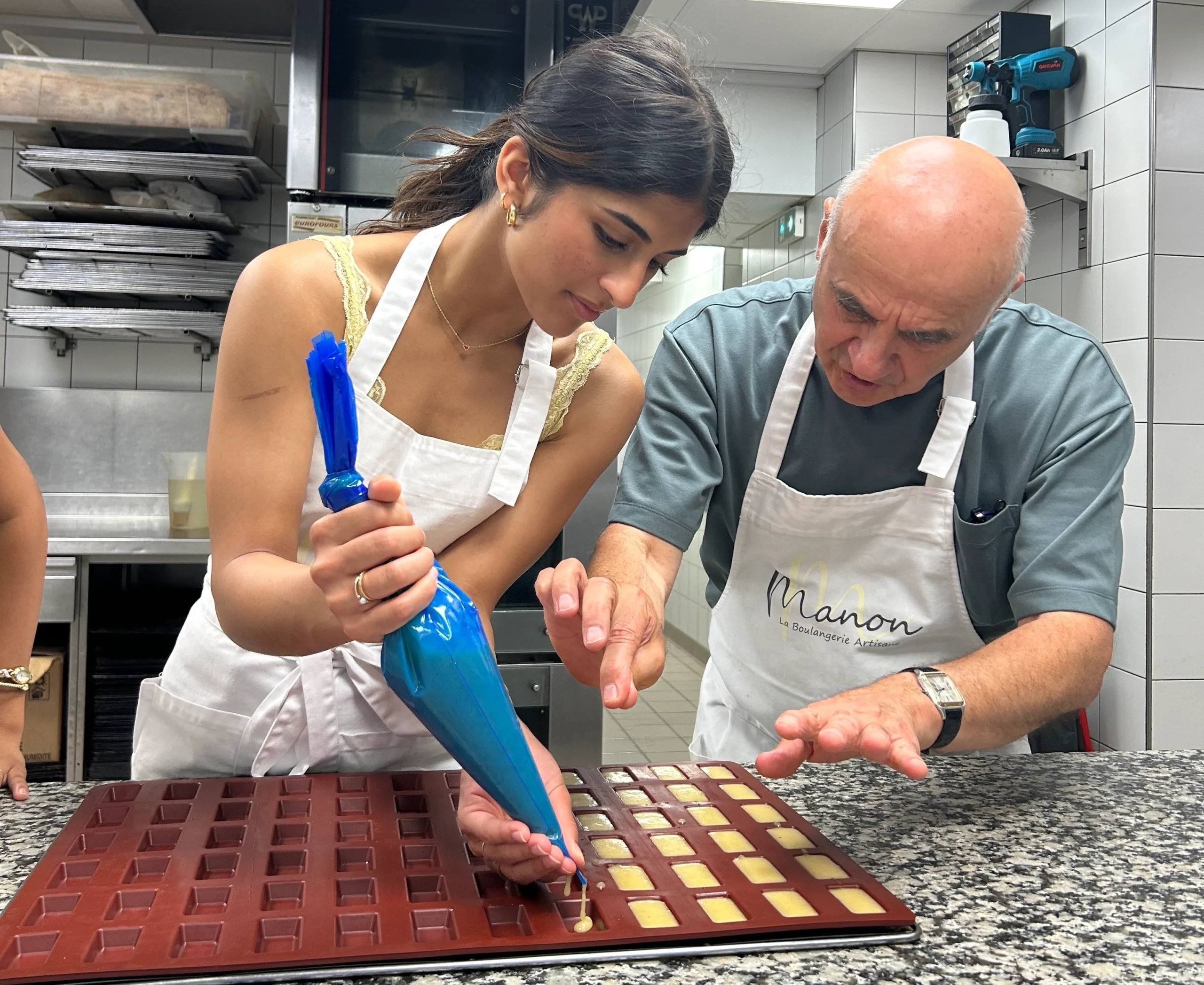 Guide showing guest how to make pastries in Paris baking class