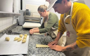 Rolling croissants in bakery class