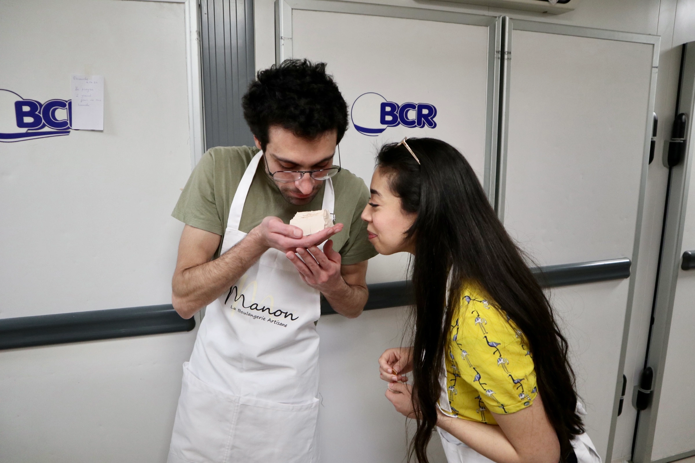 Couple with baked good during French Baking Experience in Paris
