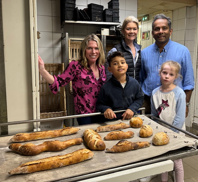 Family with baguettes during French Baking Experience