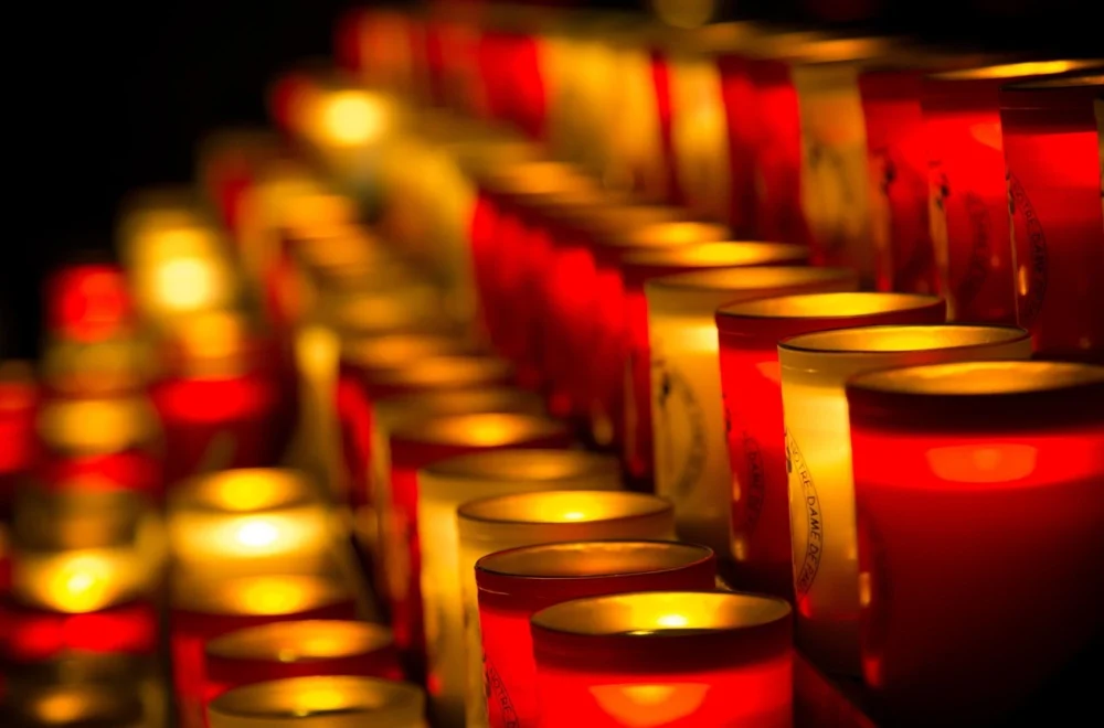 Close up of lit candles inside Notre Dame Cathedral