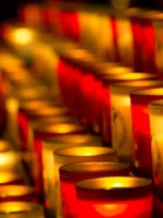 Close up of lit candles inside Notre Dame Cathedral