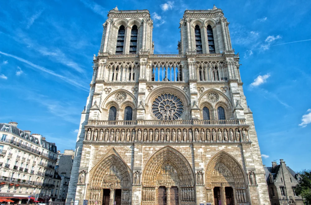 Facade of Notre Dame cathedral in Paris on a sunny day