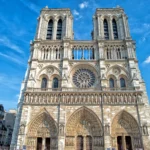Facade of Notre Dame cathedral in Paris on a sunny day