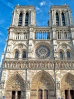 Facade of Notre Dame cathedral in Paris on a sunny day