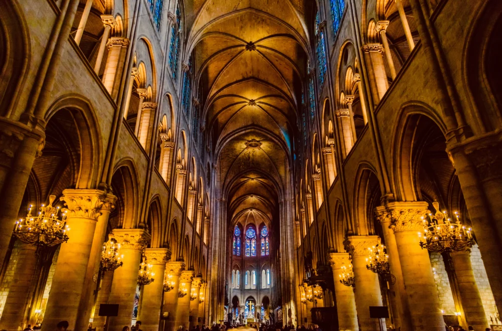 The interior of Notre Dame cathedral In Paris with lit candles during Notre Dame Guided Tour